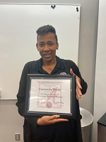 Constance Darby holding her accountant technician program certificate from UA.