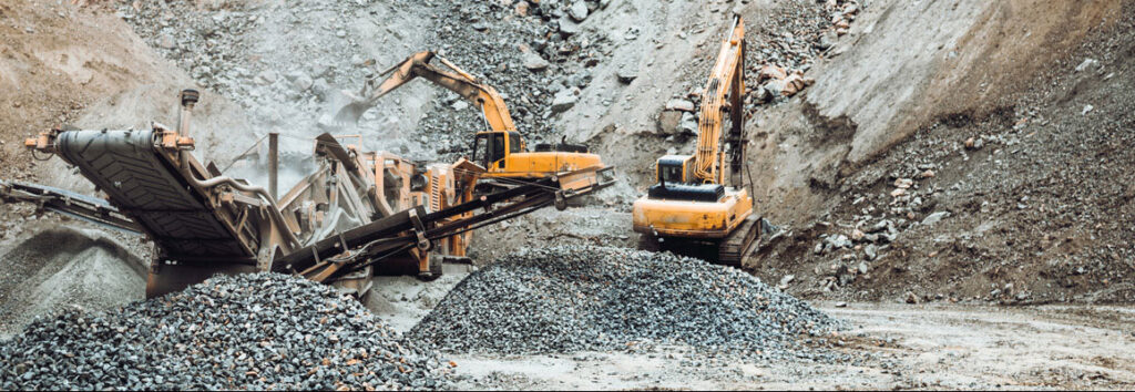 Excavators and construction equipment breaking into the ground