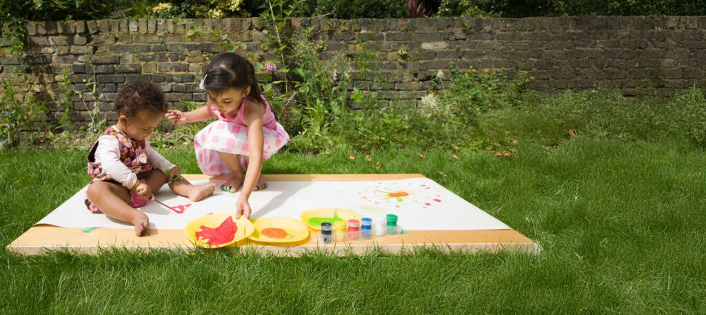 Children painting in the garden