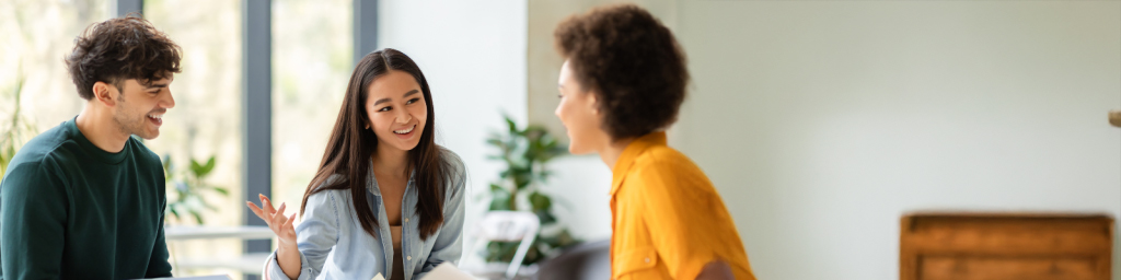 Three people sitting at table having a discussion